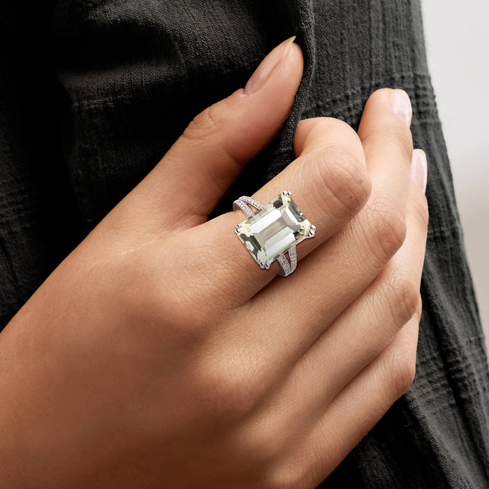 Sterling silver prasiolite ring on hand with emerald-cut center and small white stones