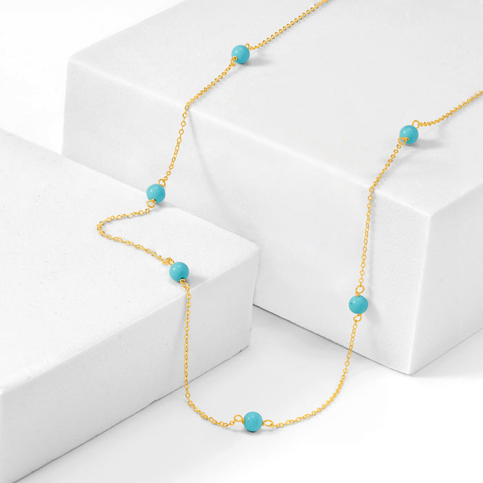 Turquoise bead station necklace angled; round blue beads on 14kt yellow gold chain