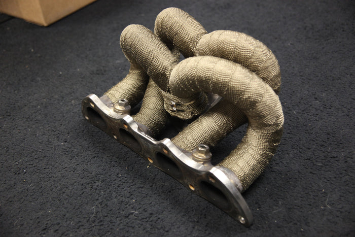 Titanium header wrap on header